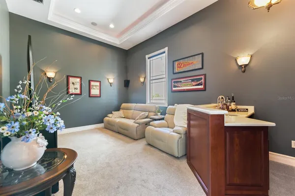 an aerial view of a house with a garden and lake view