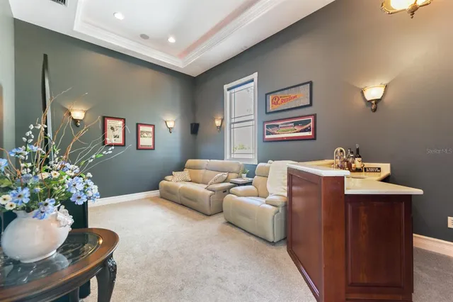 an aerial view of a house with a garden and lake view