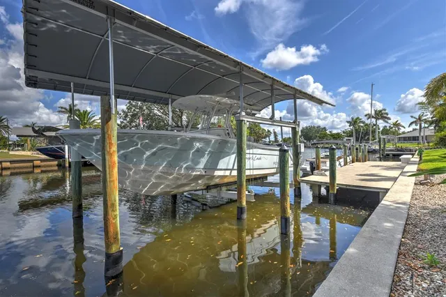 a living room with furniture a chandelier and a dining table