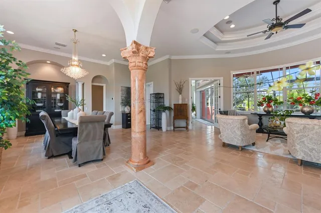 a view of a dining room with furniture and chandelier