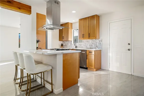 a kitchen with stainless steel appliances granite countertop a sink and a refrigerator