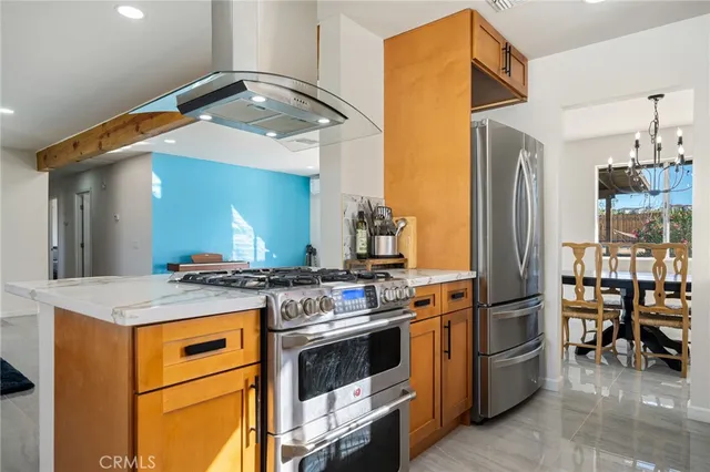 a kitchen with stainless steel appliances a stove and a refrigerator