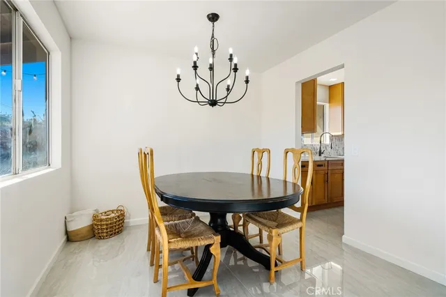 a view of a dining room with furniture and window