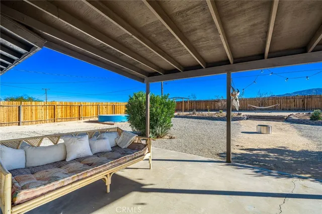 a view of a patio with table and chairs