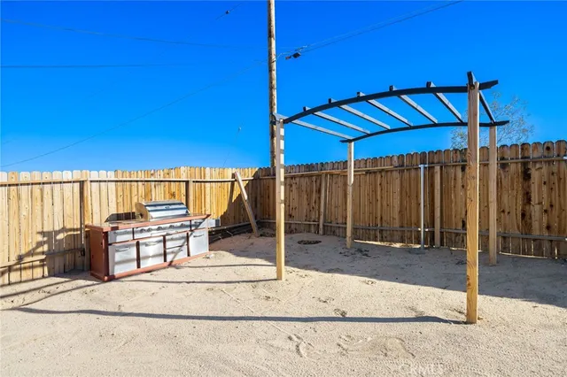 a view of a patio with table and chairs