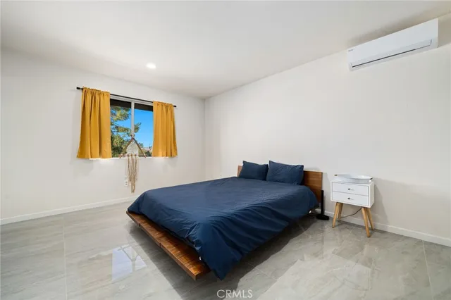 a bedroom with a bed and dresser