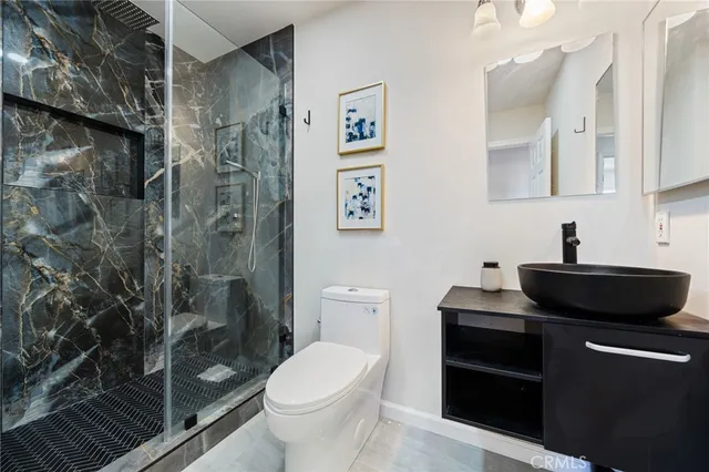 a view of a bathroom with toilet sink and a mirror