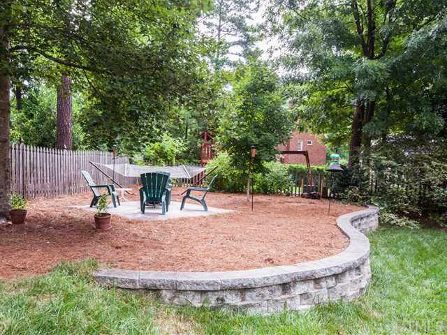 1917 Prescott Place Raleigh, NC 27615 - Photo 24 of 25 A decorative stone wall leads to a patio that is located in the back corner of the yard. Patio/Deck