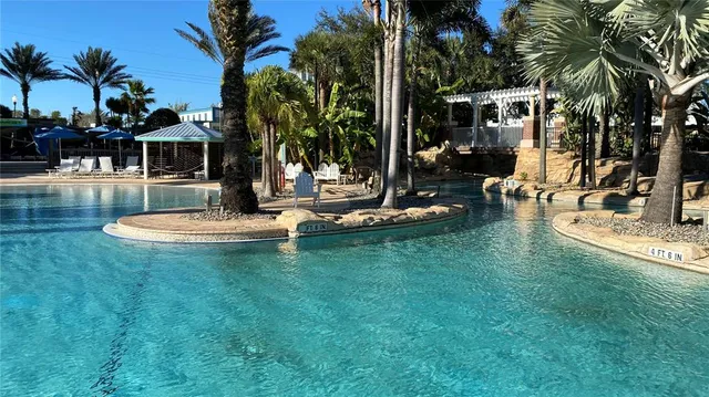 a view of a swimming pool with a table and chairs