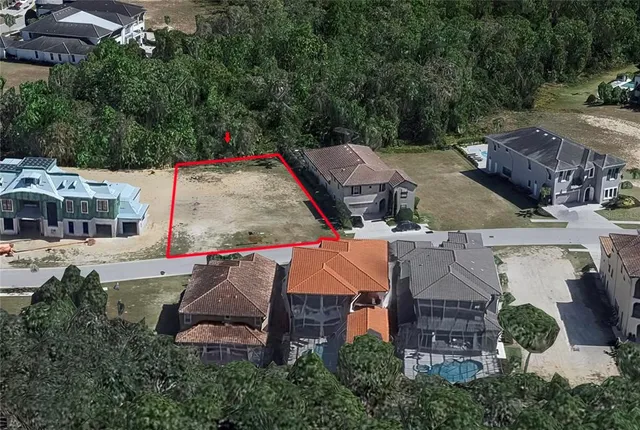 an aerial view of a house with swimming pool and a yard