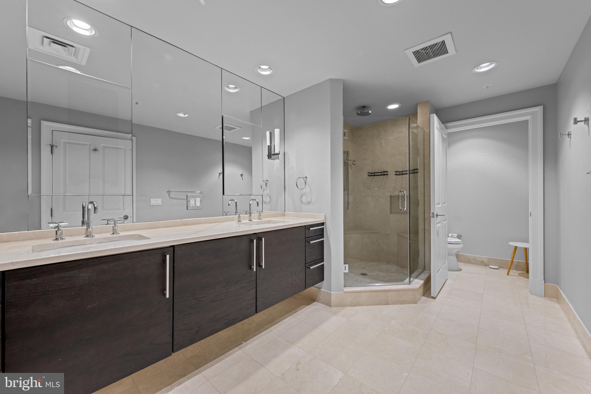 801 Key Highway, Unit 458 Baltimore, MD 21230 - Photo 27 of 48 a bathroom with a shower sink double and mirror