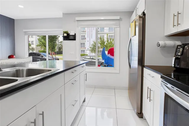 a kitchen with a sink appliances and a window