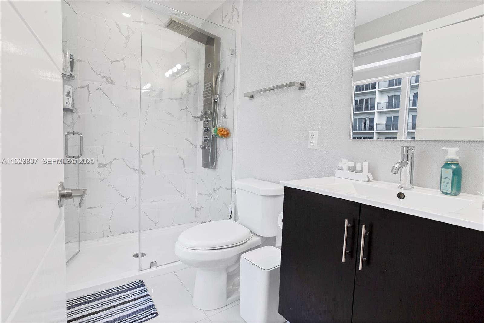 25872 Southwest 139th Path Homestead, FL 33032 - Photo 18 of 51 a bathroom with a sink toilet a mirror and shower