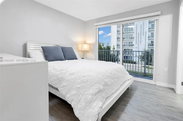 a large bed sitting in a bedroom next to a window