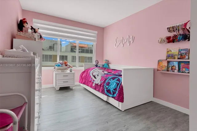 a bedroom with furniture and a large window