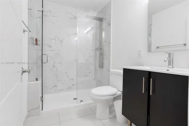 a bathroom with a shower toilet and sink