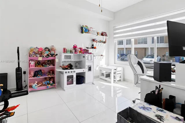 a kitchen with kitchen island a stove and a flat screen tv