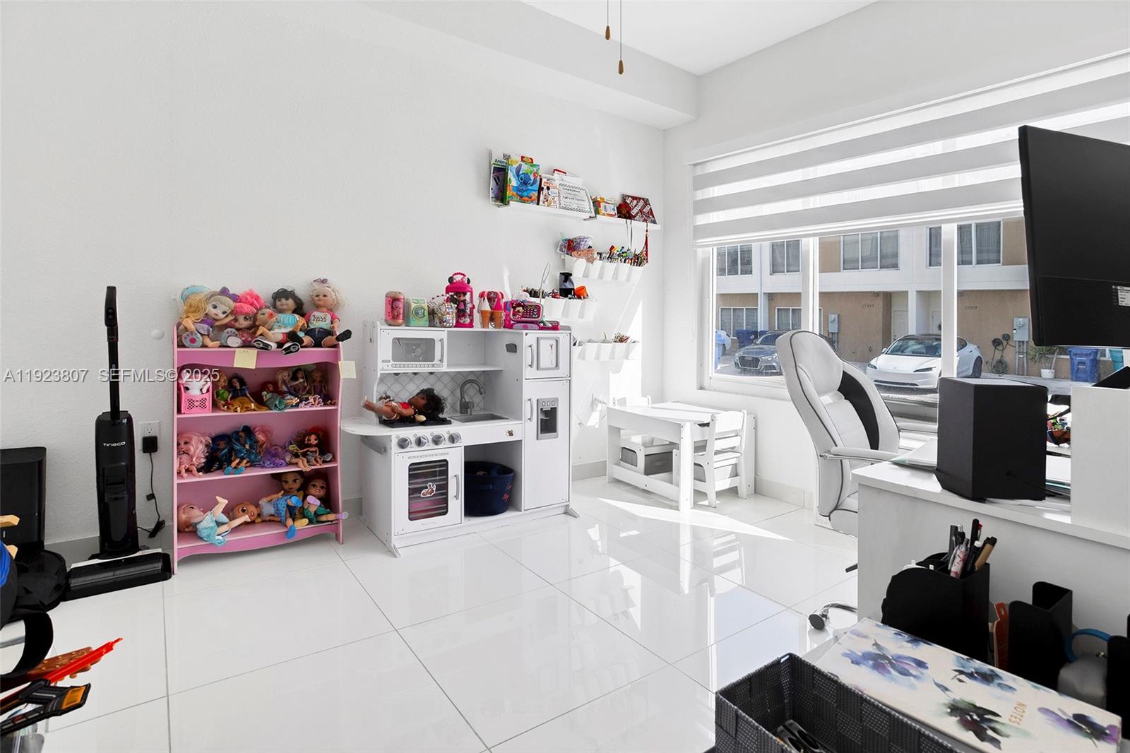 25872 Southwest 139th Path Homestead, FL 33032 - Photo 34 of 51 a kitchen with kitchen island a stove and a flat screen tv