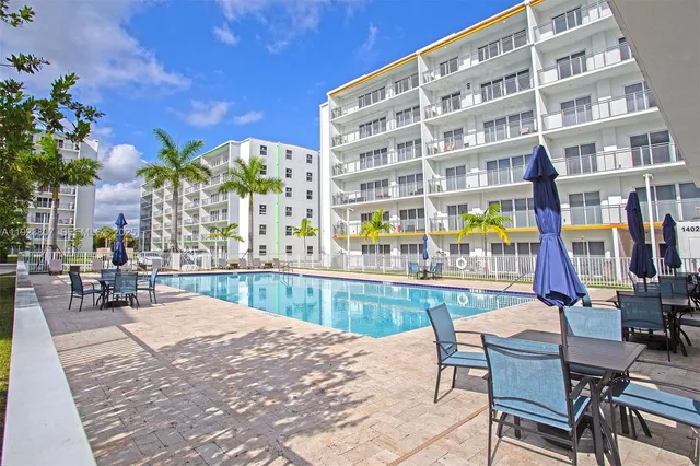a swimming pool with outdoor seating and yard