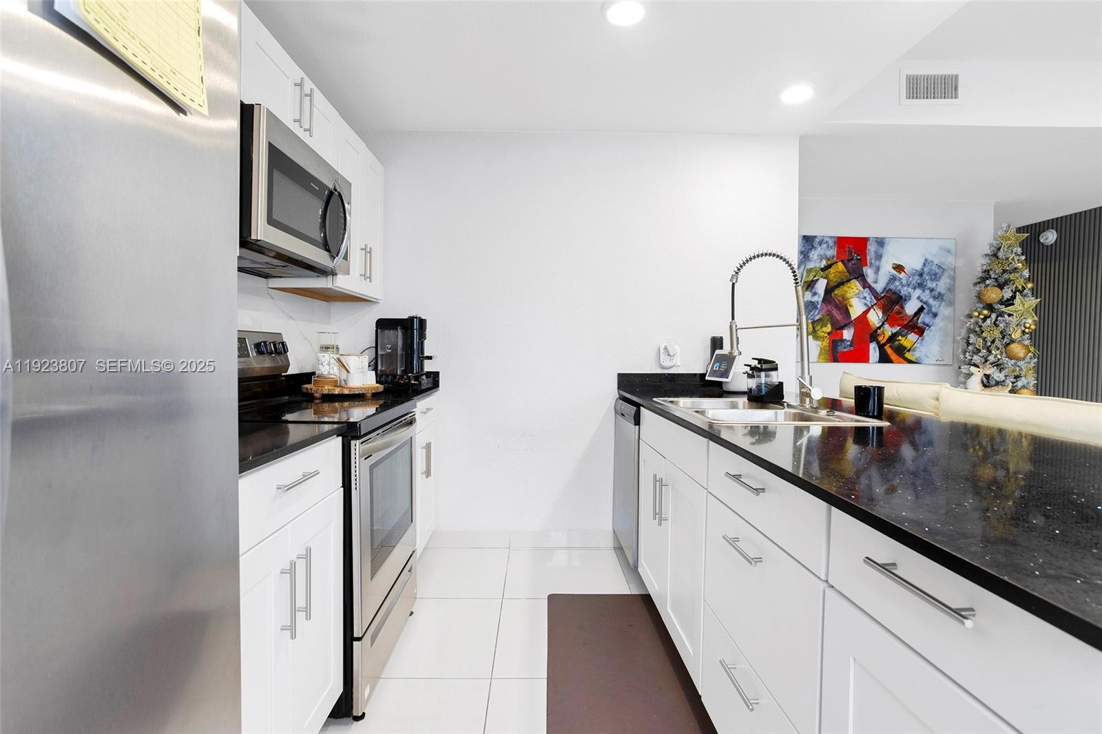 25872 Southwest 139th Path Homestead, FL 33032 - Photo 10 of 51 a kitchen with stainless steel appliances granite countertop a sink and cabinets