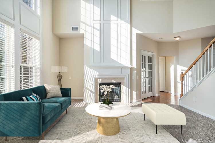 2300 Coltsgate Road Waxhaw, NC 28173 - Photo 2 of 21 a living room with furniture a fireplace and a large window
