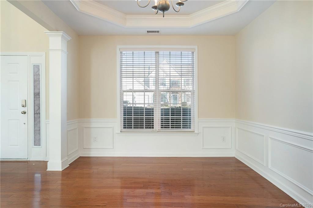 2300 Coltsgate Road Waxhaw, NC 28173 - Photo 12 of 21 an empty room with wooden floor and windows