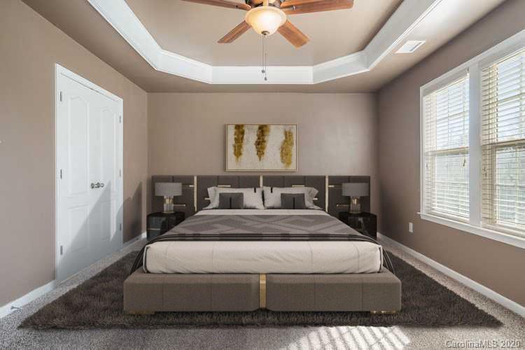 2300 Coltsgate Road Waxhaw, NC 28173 - Photo 3 of 21 a spacious bedroom with a bed and a chandelier