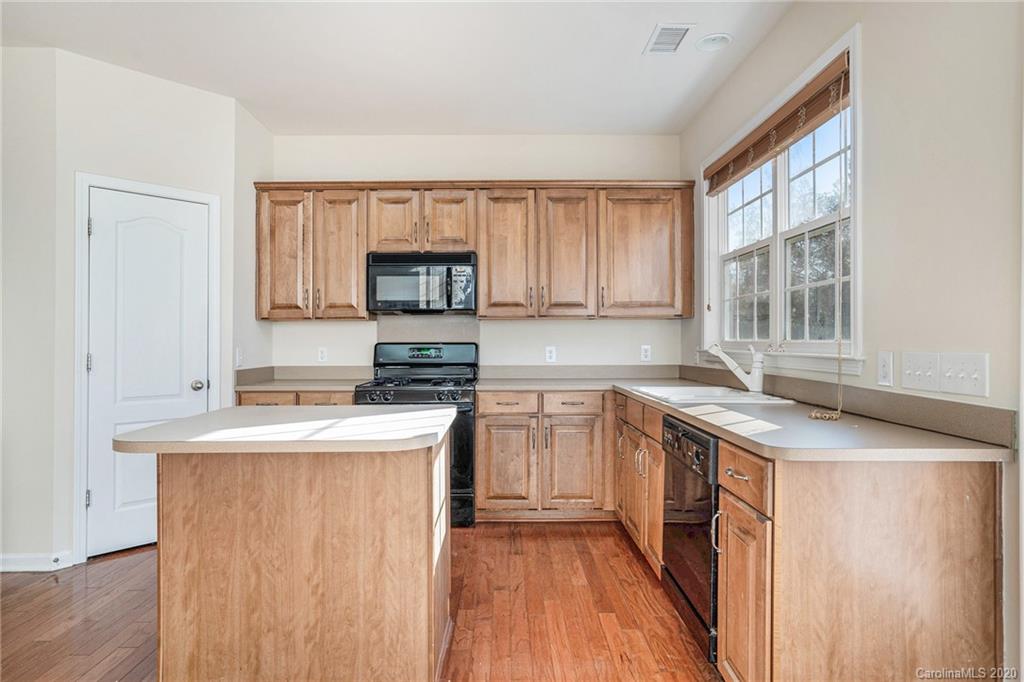 2300 Coltsgate Road Waxhaw, NC 28173 - Photo 4 of 21 a kitchen with a stove a sink and a microwave