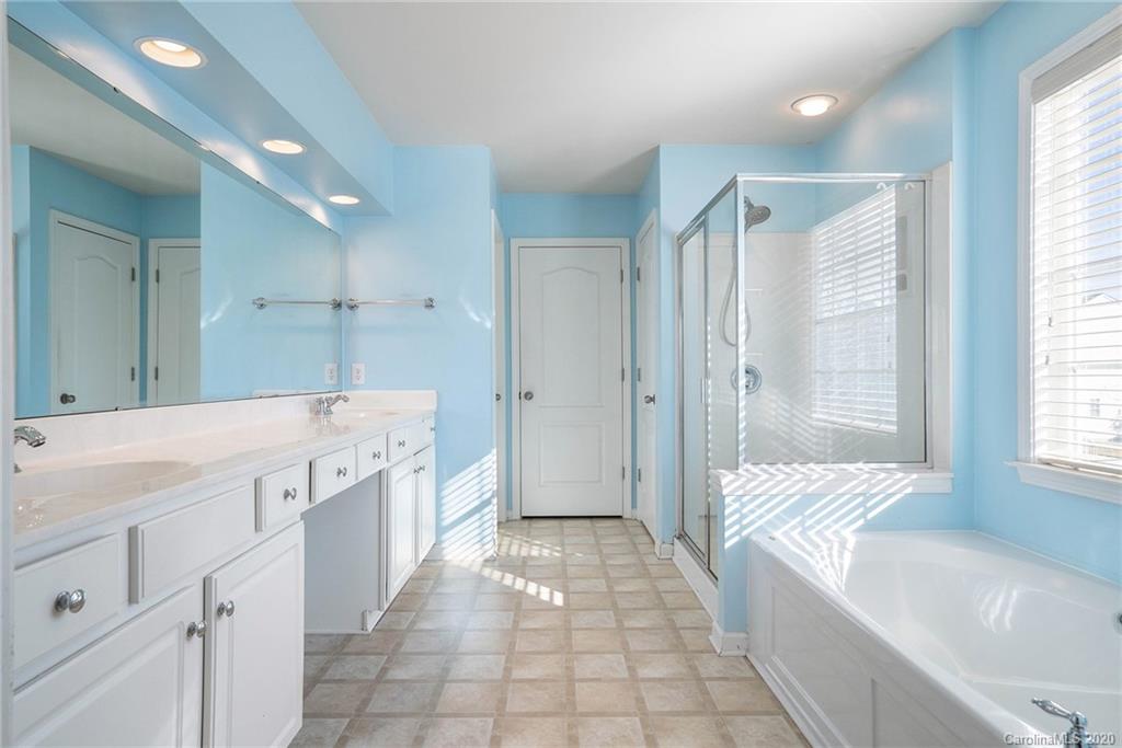 2300 Coltsgate Road Waxhaw, NC 28173 - Photo 6 of 21 a spacious bathroom with a tub sink shower and mirror