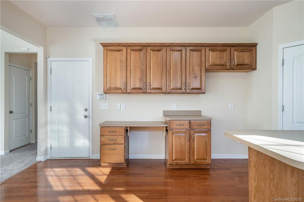 2300 Coltsgate Road Waxhaw, NC 28173 - Photo 8 of 21 a view of a kitchen with wooden floor and cabinets