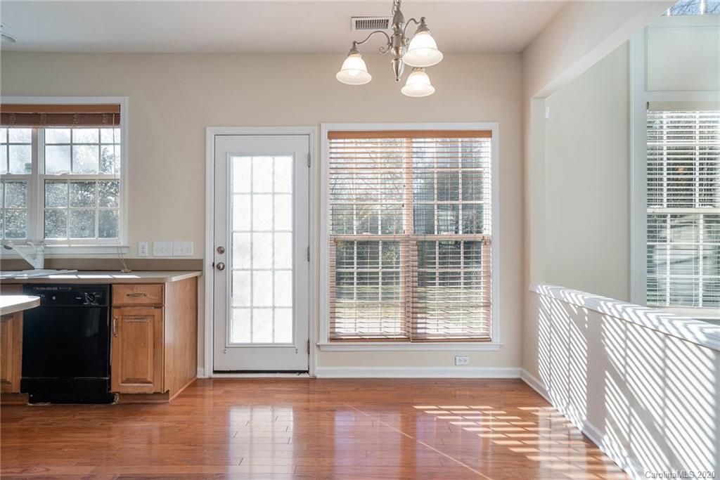 2300 Coltsgate Road Waxhaw, NC 28173 - Photo 9 of 21 a view of a room with wooden floor and chandelier