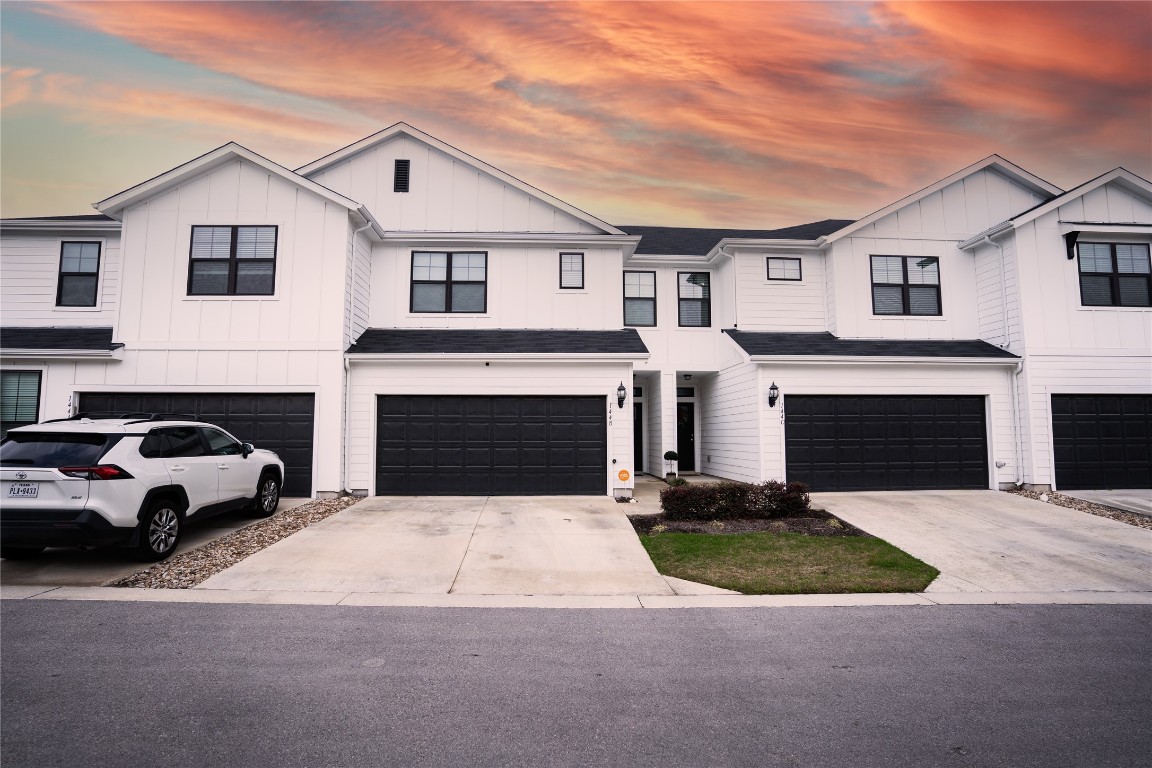 144 B Threshing Road Buda, TX 78610 - Photo 1 of 1 a view of a white house with a yard and parking space