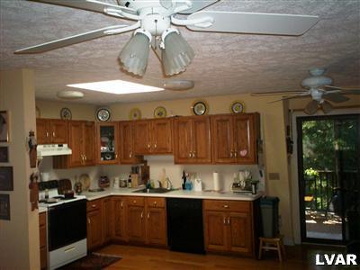 4670 McDermott Road Bangor, PA 18013 - Photo 4 of 10 a kitchen with stainless steel appliances granite countertop a sink and wooden cabinets