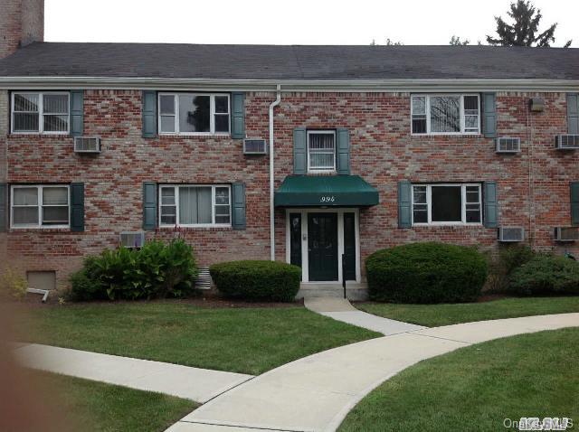 994 Fenwood Drive, Unit 2 Valley Stream, NY 11580 - Photo 1 of 1 a front view of a house with garden