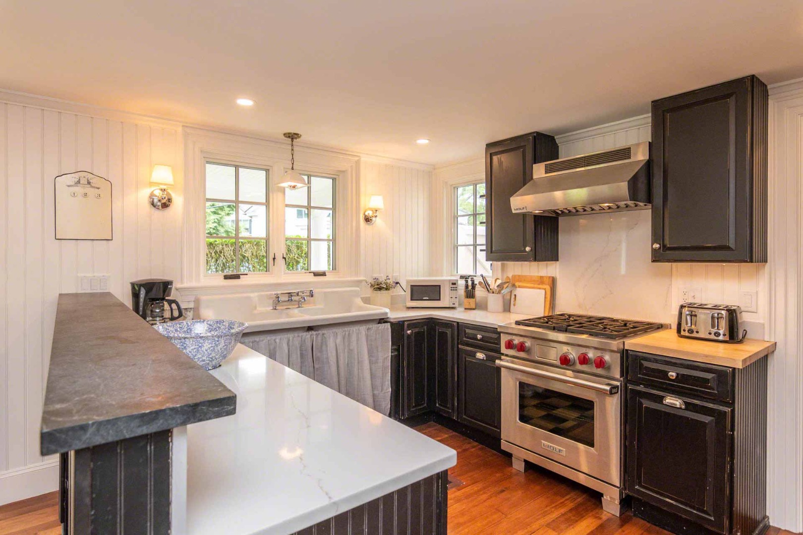 16 Mill Street Edgartown, MA 02539 - Photo 17 of 42 a kitchen with stainless steel appliances granite countertop a sink stove and refrigerator