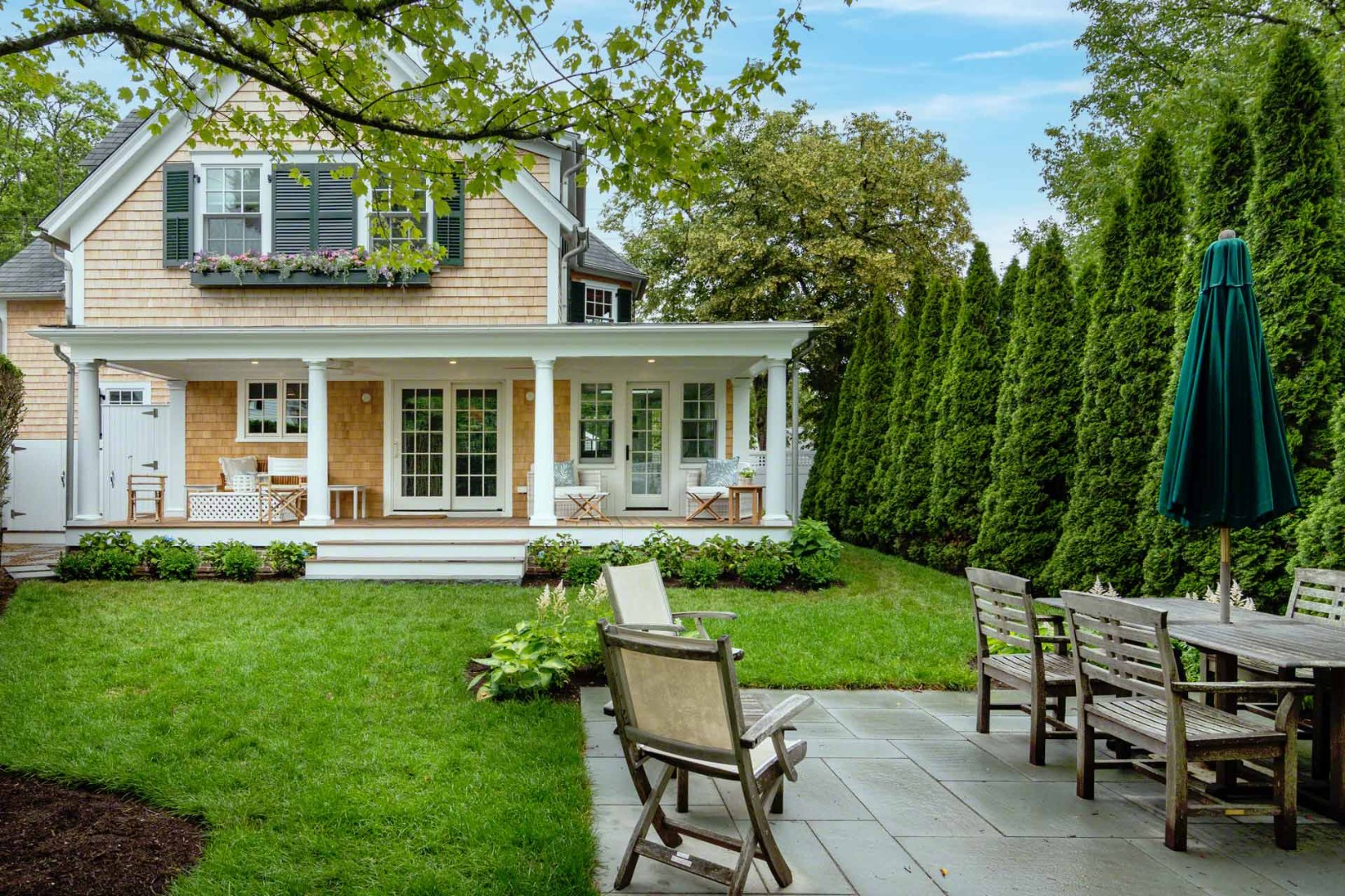 16 Mill Street Edgartown, MA 02539 - Photo 39 of 42 a view of a house with backyard sitting area and garden