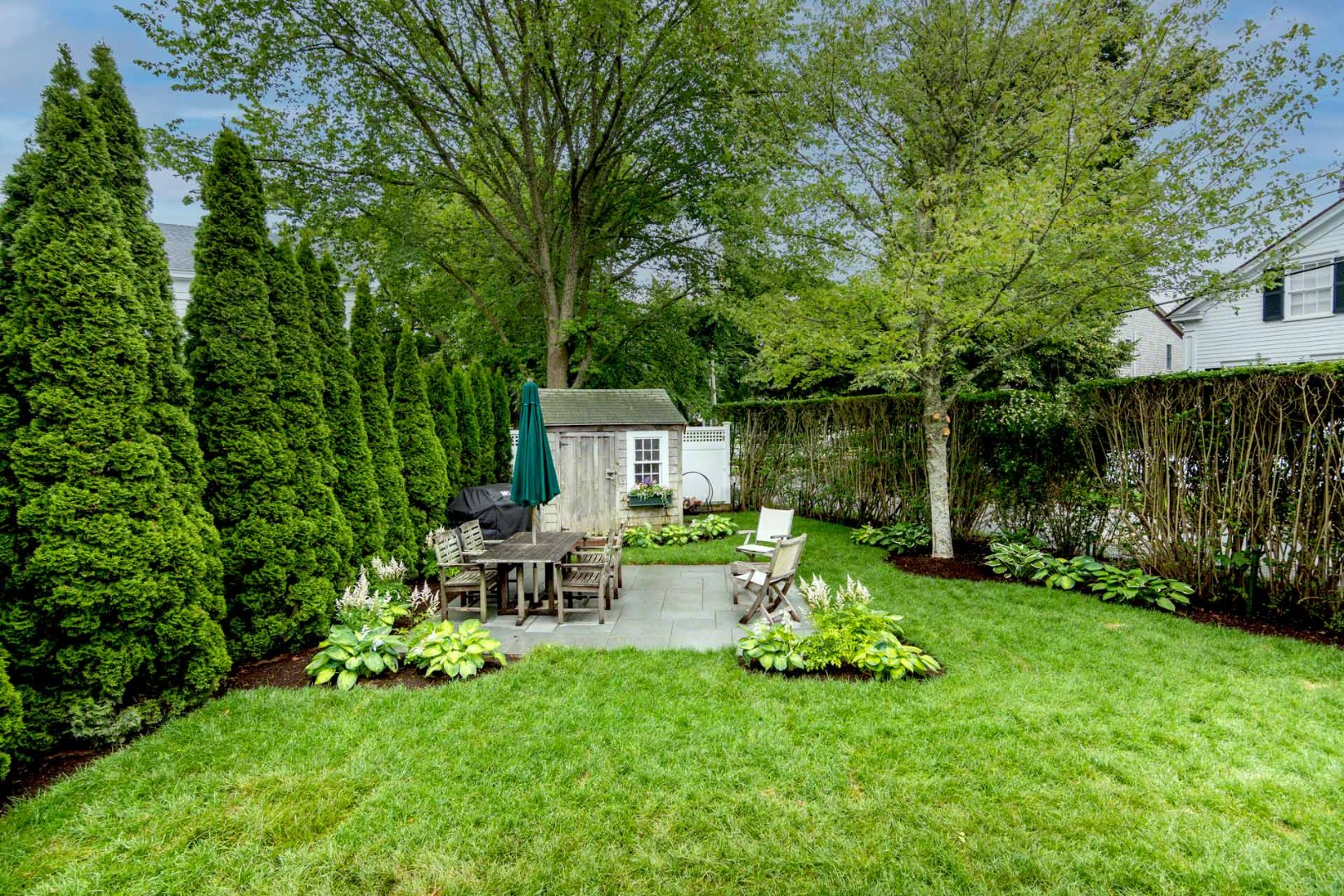 16 Mill Street Edgartown, MA 02539 - Photo 42 of 42 a view of a chair and table in backyard of the house