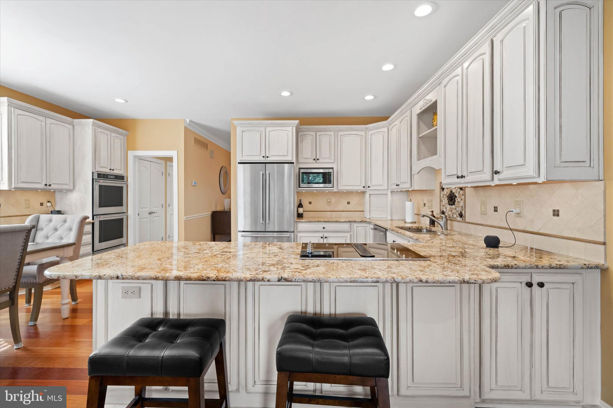 103 Downs Drive Wilmington, DE 19807 - Photo 12 of 70 a kitchen with stainless steel appliances granite countertop a sink refrigerator and cabinets
