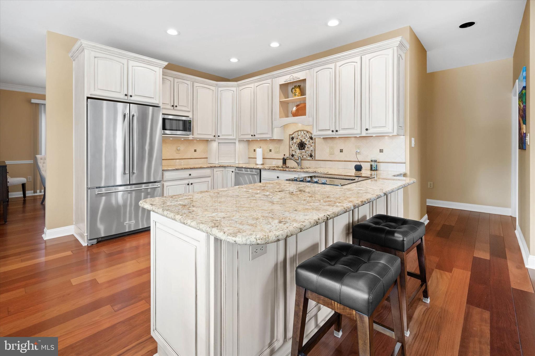 103 Downs Drive Wilmington, DE 19807 - Photo 13 of 70 a kitchen with stainless steel appliances granite countertop a stove refrigerator and wooden cabinets