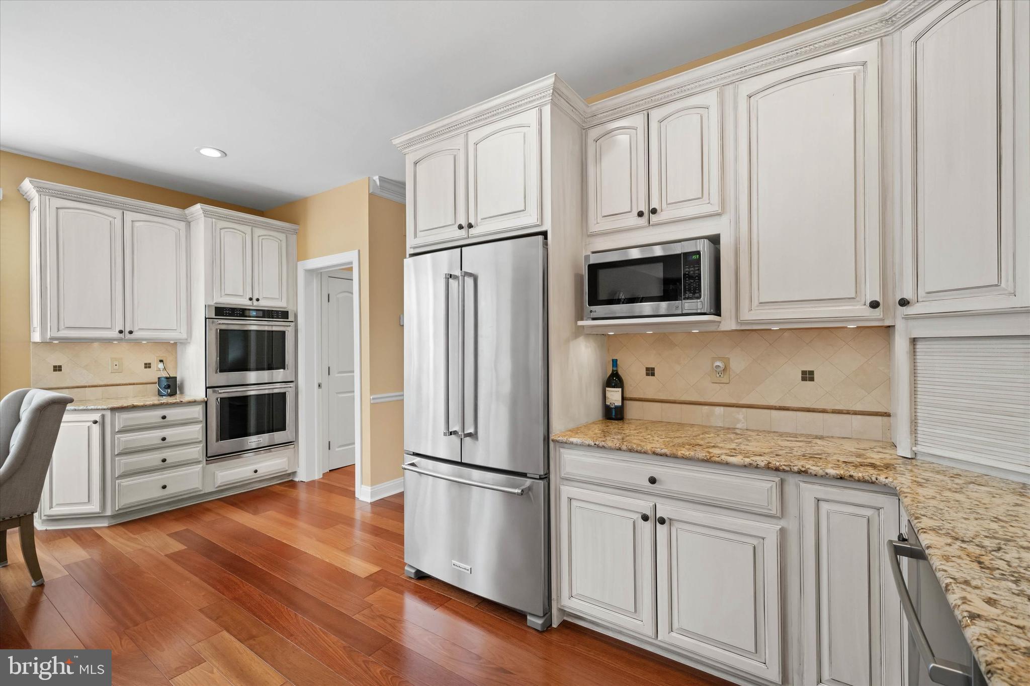 103 Downs Drive Wilmington, DE 19807 - Photo 15 of 70 a kitchen with granite countertop white cabinets and stainless steel appliances