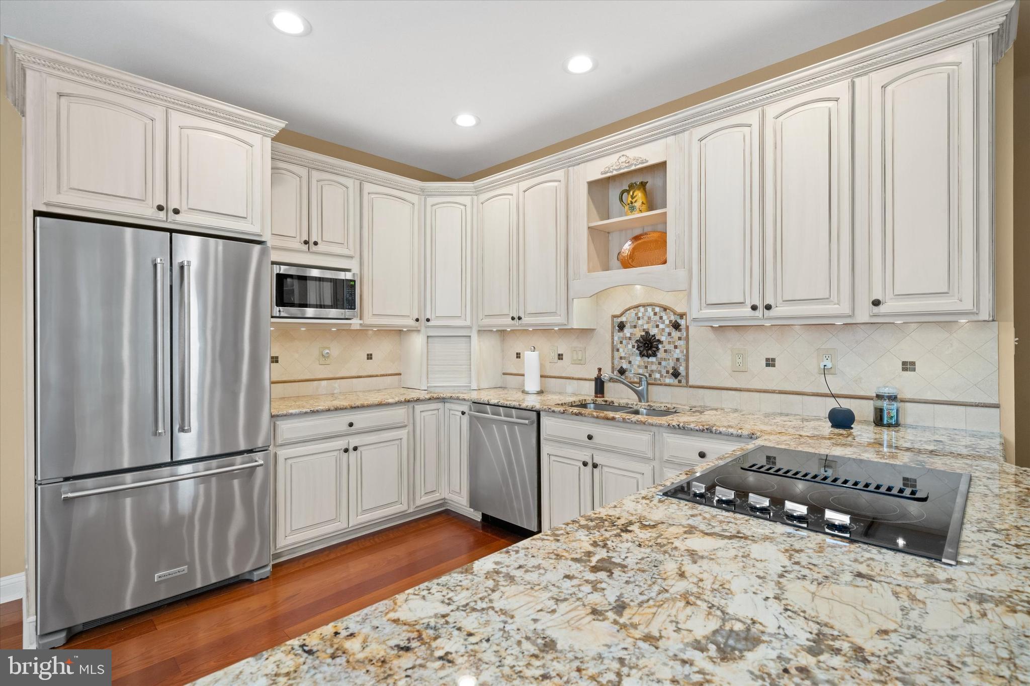 103 Downs Drive Wilmington, DE 19807 - Photo 16 of 70 a kitchen with stainless steel appliances granite countertop a refrigerator sink and cabinets