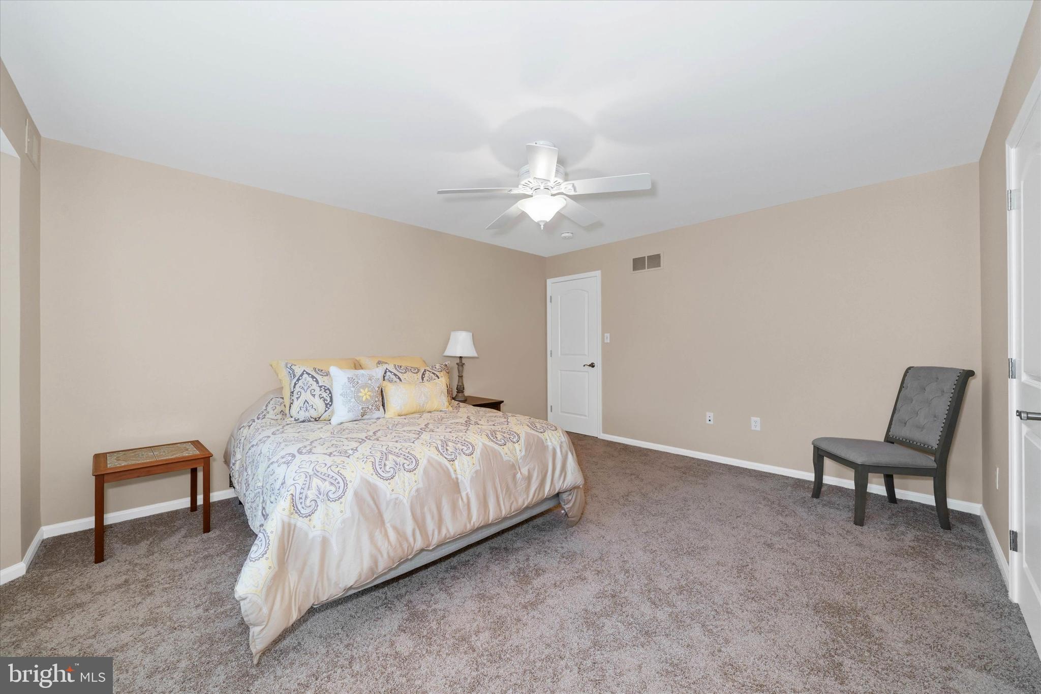 103 Downs Drive Wilmington, DE 19807 - Photo 38 of 70 a bedroom with a bed and a chair