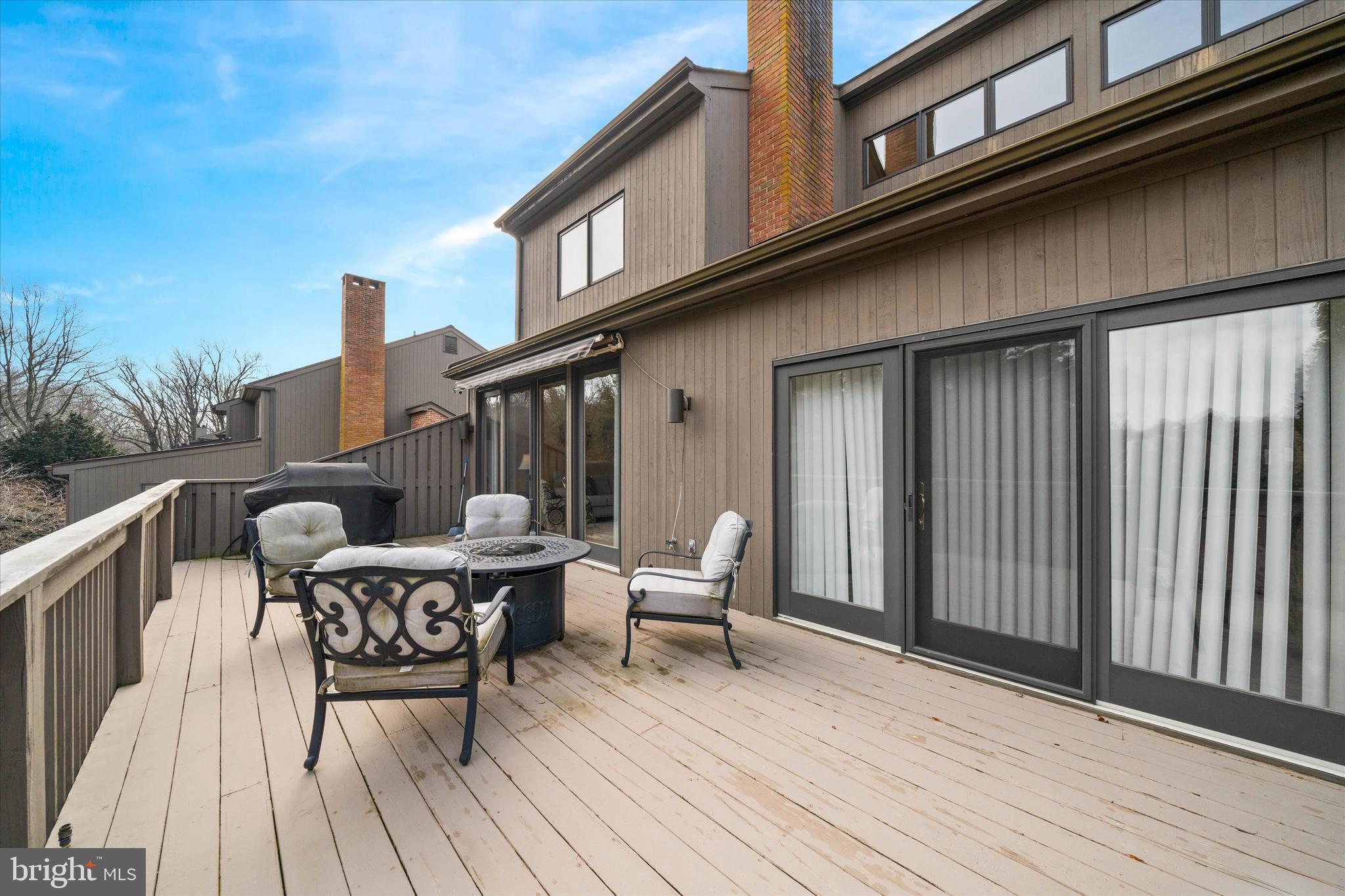 103 Downs Drive Wilmington, DE 19807 - Photo 60 of 70 a view of a roof deck with table and chairs and wooden floor