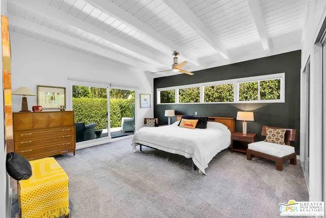 a bed room with a bed and a chair