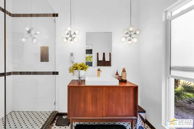 a view of a hallway with dining table and chandelier