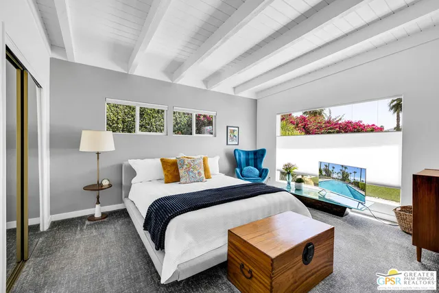 a bedroom with a large bed and a window