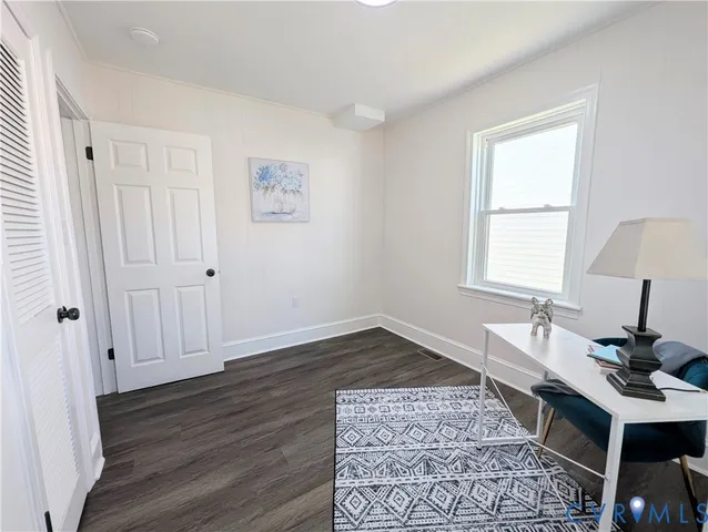 a workspace with wooden floor and a window
