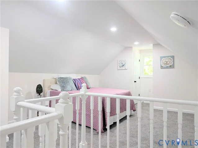 a bedroom with a bed with wooden floor