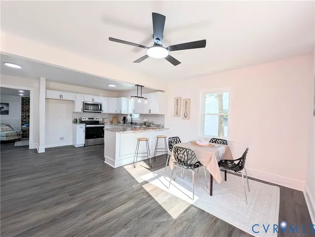 a living room with stainless steel appliances kitchen island granite countertop furniture and a kitchen view