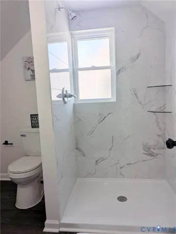 a bath room with a toilet and a bath tub